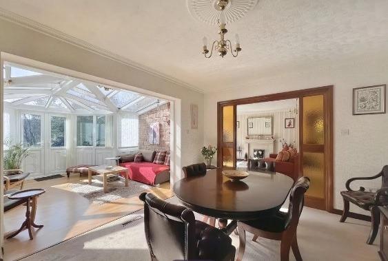 The dining room sits between the lounge and the conservatory, the wide archways and open-plan layout giving a flow-through feel to the house.