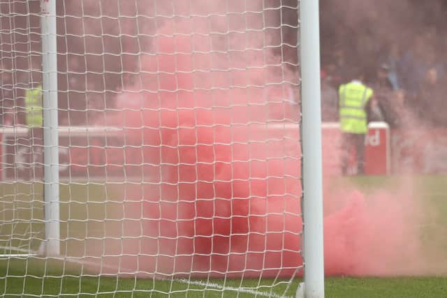 A Wrexham fan has been banned for five years after setting off a flare against Chesterfield.