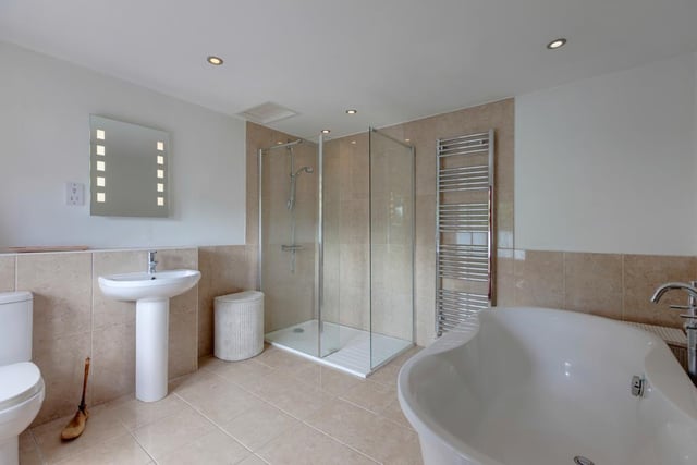 This one of the property's two family bathrooms. It has a freestanding Phoenix bath and a separate walk-in shower enclosure.