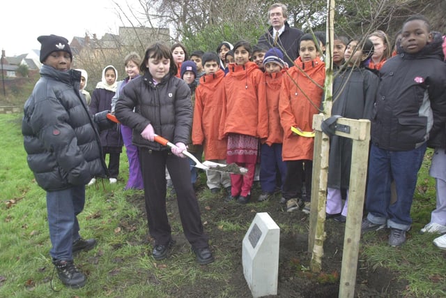 Pictured in Abbeyfield Park in 2002 wa the Holocaust Memorial stone and tree planted  by children from Firs Hill and Byron Wood Schools. Seen   are pupils Melissa Oxley, and Raymond Steele as they put soil around the site watched by other pupils, and Director of Education Jonathan Crossley-Holland
