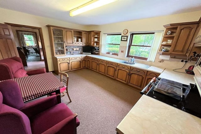 This spacious room contains a new dual fuel gas and electric range cooker and is fitted with an extensive range of solid wood wall and base storage cupboards.