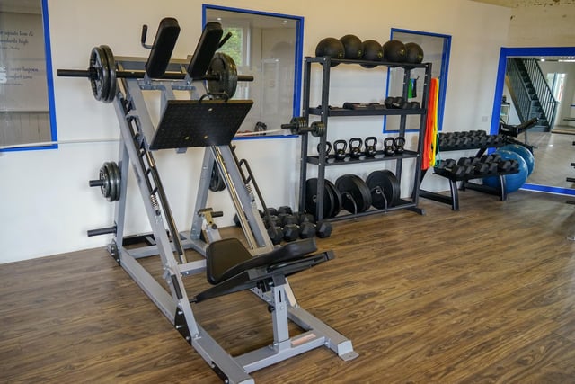Strength training machines and cardio machines are contained within the gym.
