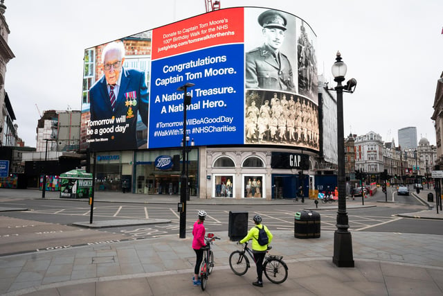 An hourly salute to Captain Tom the army veteran in Piccadilly Circus, London. 99-year-old war veteran Captain Tom Moore's challenge to raise money for NHS charities to walk 100 laps of his garden before his 100th birthday has hit £20 million, less than two weeks after he began the challenge. He completed his 100 laps on Thursday.