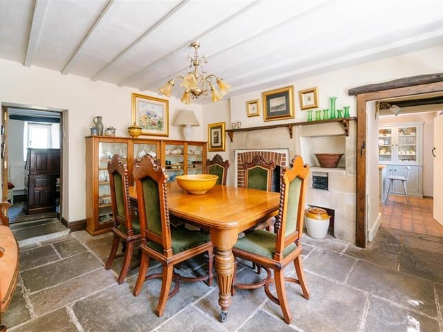 Flagstone floor and bare wood frame around the door highlight the character of the farmhouse.