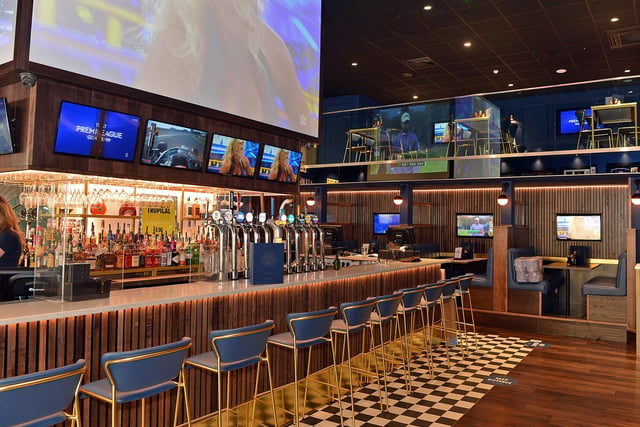There is casual bar seating downstairs, and restaurant-style seating on the mezzanine above. Booths have individual screens that can be tuned to sports of customers' choice.