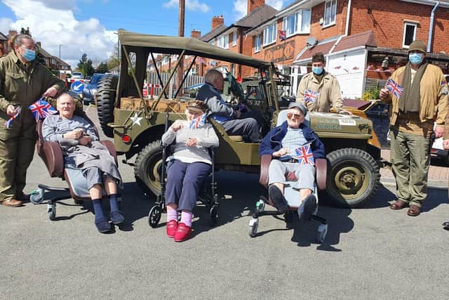 Residents of the Langdale Lodge care home with members of the re-enactment society and their vehicles.