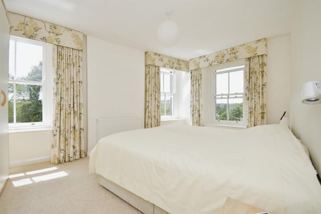 This gorgeous bedroom, one of four, has panoramic views and is bathed in natural light.