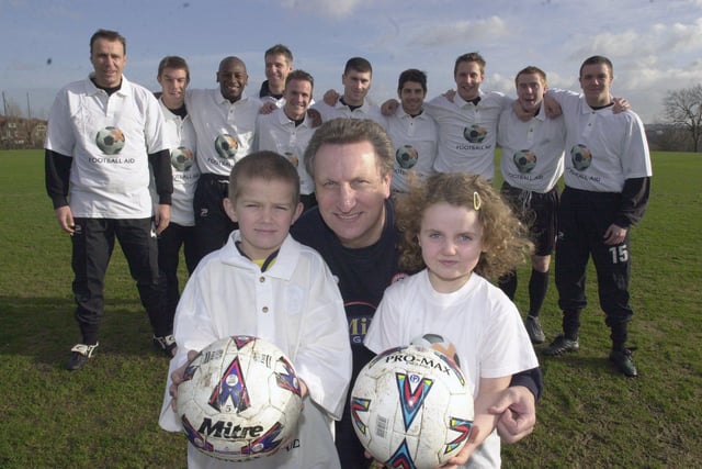 Neil Warnock and Sheffield United players pictured at the United training ground with Daniel Phelan, eight, and Holly Emsley, five, from the Diabetic Department, Shefield Childrens Hospital pictured in 2002