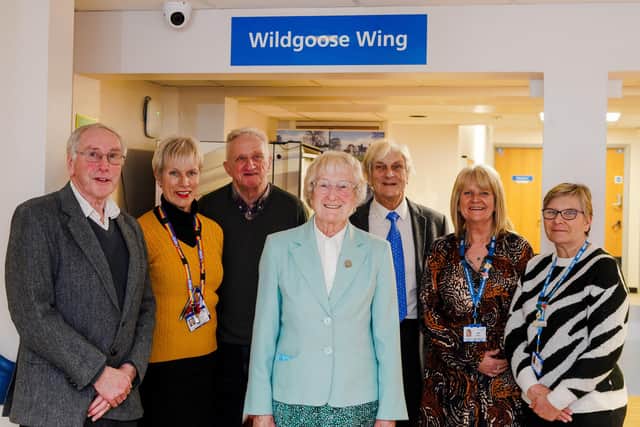 Pam Wildgoose (centre) is pictured underneath her new Wildgoose Wing signage at Whitworth Hospital with (from left) Pete Vincent (league chair), Melissa Dalton (senior specialist nurse), Brian Wood (league treasurer), Tom Pilkington (league community representative), Jane Bull and Lisa Trantham (Whitworth Hospital facilities management).