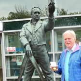Dr Peter Broughton with his George Stephenson Medal by the statue outside Chesterfield railway station.