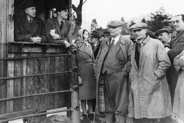 William Cavendish, Marquess of Hartington (1917 - 1944, second from left), pictured addressing farmers from the auctioneers' rostrum at Bakewell Cattle Market during the West Derbyshire by-election, in February 1944, his sister Lady Elizabeth Cavendish is next to him. He was standing as the Conservative (Wartime Coalition) candidate. (Photo by Keystone/Hulton Archive/Getty Images)