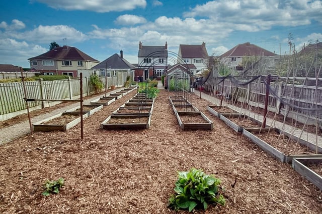 An extensive vegetable plot in the rear garden where there is also a lawn and a patio. A greenhouse, potting shed, storage shed and detached garage are at the back of the property.
