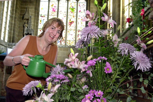'The Cathedral of the Peak' The Parish Church of Tideswell Peak District where the Jungle Book flower festival i was put on in 2003, pictured was Artistic Director Jennifer Bower helping to water some of the many displays