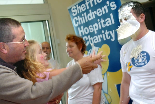 To mark 'Play in Hospital Week' patients at Sheffield Childrens Hospital had the chance to throw custard pies at staff from the hospital in 2005. Patient 4-year-old Antonia Fox  gets Kevin Hartshorn a Play Specialist at the hospital