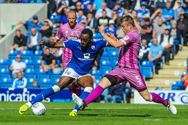 Chesterfield's Gozie Ugwu has a shot blocked by Grimsby defender Nathan Clarke.