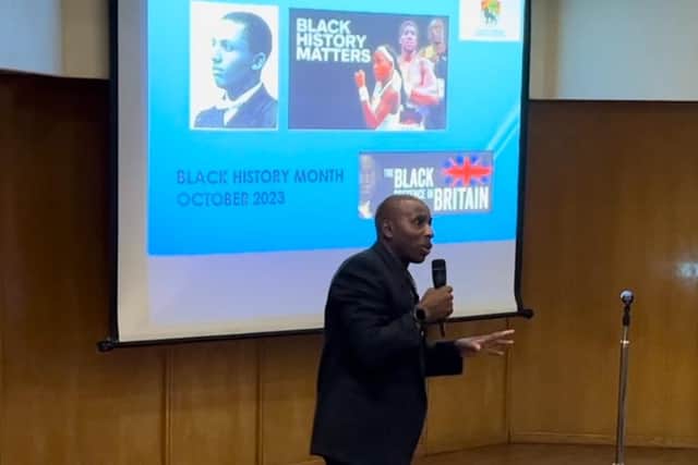 Councillor Ludwig Ramsay showing a presentation to Primary schools during the ACCA's Black History Month Exhibition