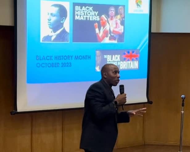 Councillor Ludwig Ramsay showing a presentation to Primary schools during the ACCA's Black History Month Exhibition