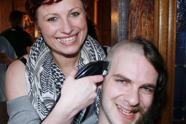 Charity headshave at The Rutland to support Ashgate Hospice. Ellen Shaw is pictured shaving Sam Madin's head, in March 2009.