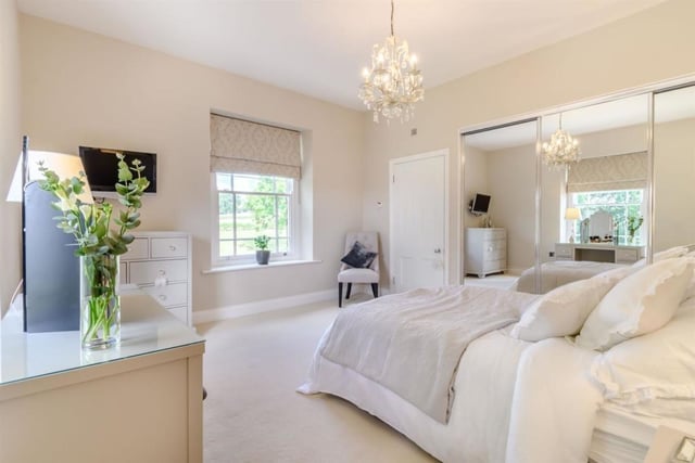 The principal bedroom suite contains contemporary fitted furniture, has an adjacent dressing room with storage behind mirrored units and an ensuite shower room.