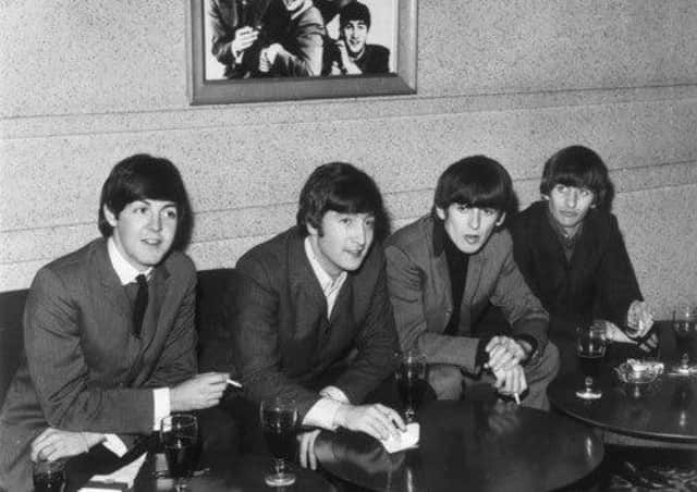 The Beatles sit down and relax with drinks at the ABC Edinburgh.