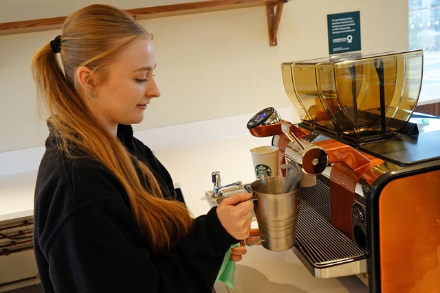 Emily Marsden (assistant manager) making a coffee.