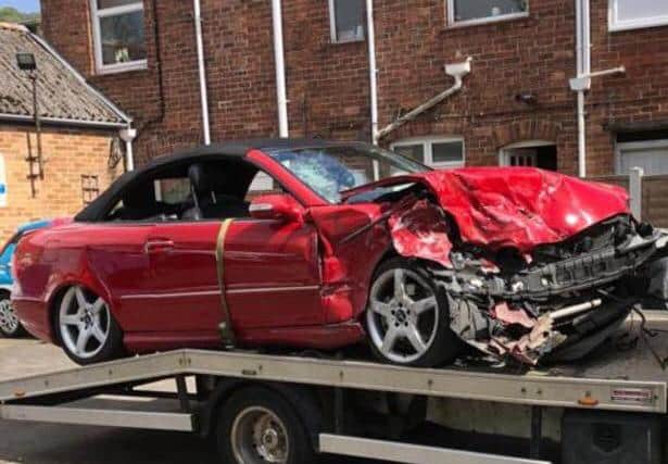 The couple's red Mercedes was battered to bits in the smash.