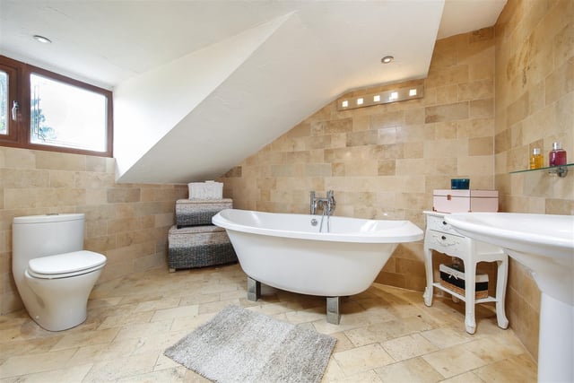 A deep and free standing bath tub is a feature of this modern bathroom.