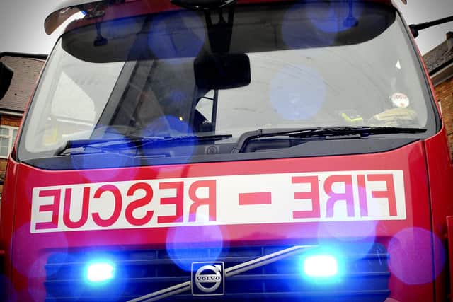 A man was taken to hospital with injuries and a busy road was closed after a fire at a property near Chesterfield.