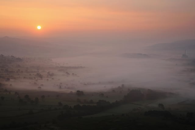 Mist lingers in Hope Valley at sunrise viewed from the top of Mam Tor. (Photo by Dan Kitwood/Getty Images)