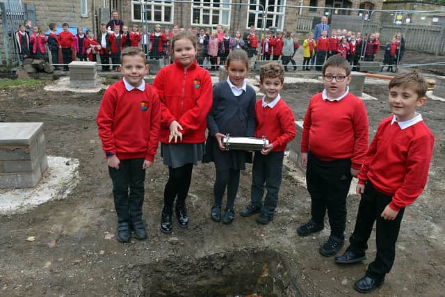 Highfield Hall Primary School pupils Harry, Susie, Elliott, Lily, Alex and Tommi-Lee during the planting of the time capsule.