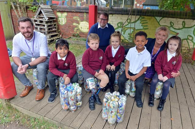 Tibshelf Infant and Nursery School headteacher Zoe Andrews with Bolsover MP Mark Fletcher, County Councillor James Barron and Year 1 and 2 pupils with their eco bricks in the outdoor area