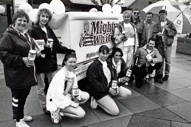 Marehay garage staff push a giant loaf as part of charity fundraising efforts in 1992.