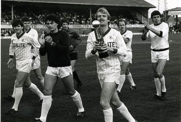 From left to right, John Seasman, Phill Walker, Brian Scrimgeour, Jim Brown, Steve Kendal, Mick Henderson and Ernie Moss, parading the Division Four title in front of the fans in May 1985.