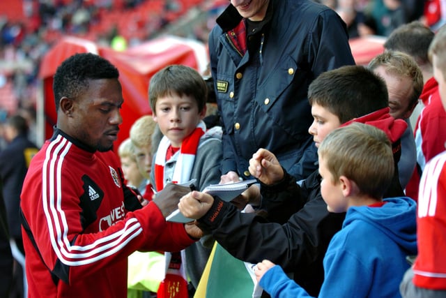 Stephane Sessegnon was pictured signing autographs for Sunderland fans before the start of the match against Wigan Athletic at the Stadium of Light in 2012.