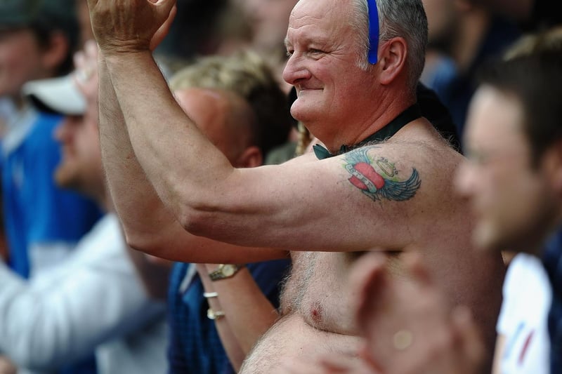 Fans cheer on the Spireites during the game against Gillingham.