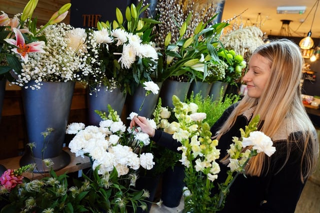 Katie Haslam selecting cut flowers for a customer.