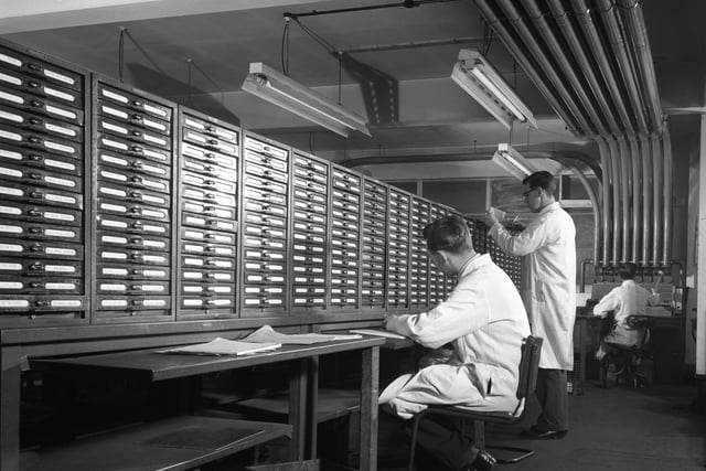 Administration staff check stock levels for the stores at Duckmanton Colliery near Chesterfield, 28 December 1962. Comunication was via Capsule Pipelines where the paperwork was sent via the compressed air tubes which can be seen in the photograph. (Photo by Paul Walters Worldwide Photography Ltd./Heritage Images/Getty Images)