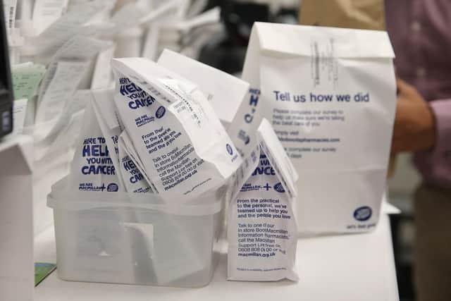 Picking up prescriptions is one way volunteers can help. Photo: Isabel Infantes/Getty