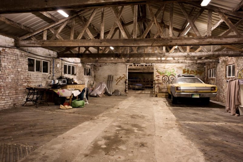 The barn includes a log preparation section and two barn doors making it ideal to store larger vehicles.