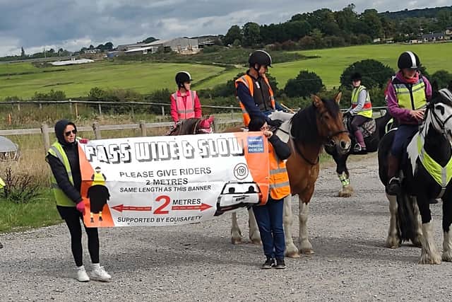 The horse riders and walkers were holding banners explaining that the drivers should keep two metres distance from a horse while passing them on the road.