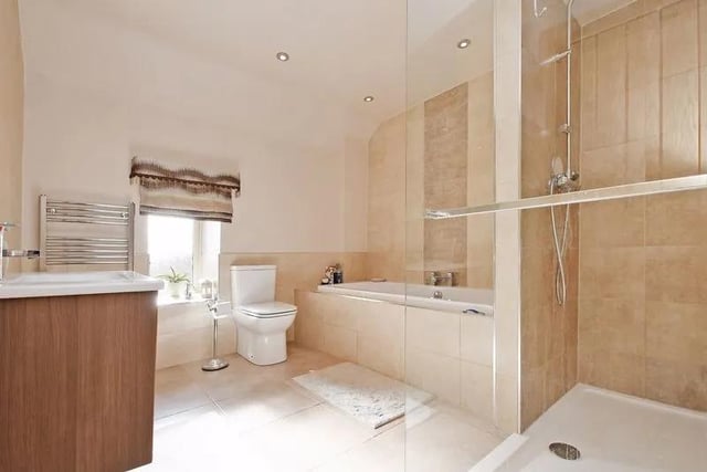 The luxury family bathroom has a white suite, double ended bath and separate walk in shower.