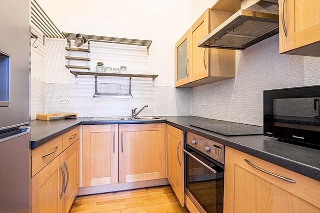 The kitchen is located off the main living room and has an integrated washer dryer, oven, hob, extractor fan and space for a fridge freezer.