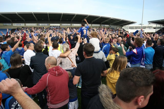 Fans celebrate and invade the pitch.