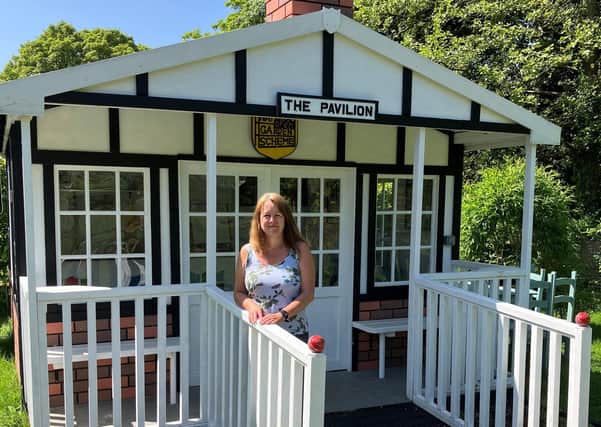 Tracy Reid in her cricket pavilion-style summerhouse, a 50th birthday present from her husband, where she will serve teas during her open garden weekend.