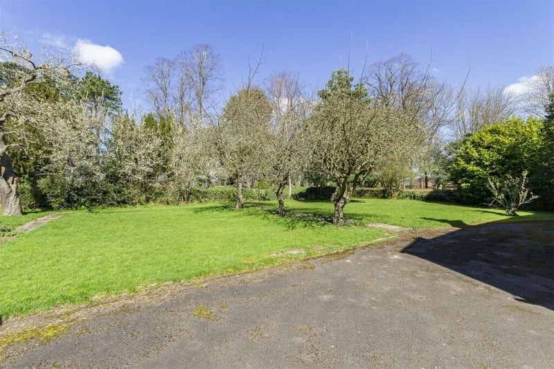 Two driveways, offering ample off-road parking space, lead to the house.