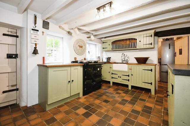 The kitchen reflects country living and has been designed to offer warmth and character. Bespoke wall and base units are complemented with high level open plate racking and a sunken porcelain sink. There is space for a range style cooker.
