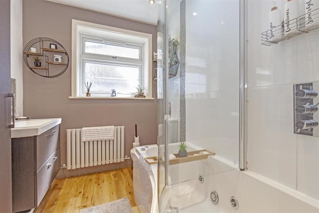 This luxury bathroom on the ground floor contains a spa shower bath, hand basin set in a modern vanity unit and a wc.
