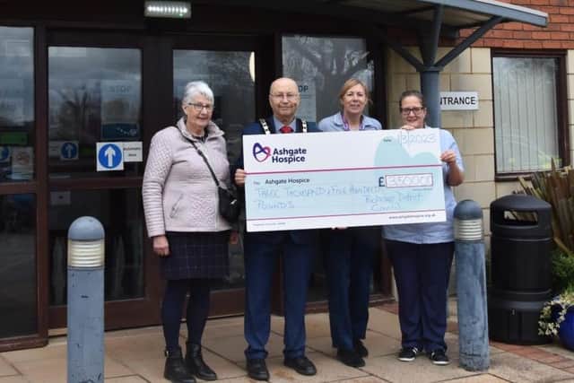 Pictured is Bolsover District Council Chair, Cllr Tom Munro and his wife Diane (left) presenting Ashgate Hospice with a cheque for £3,500