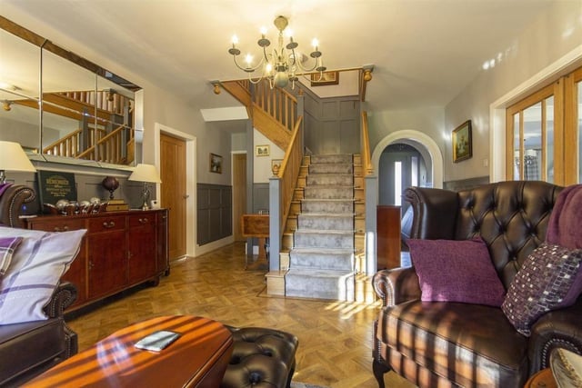 The entrance hall is spacious enough to accommodate a sitting room area. Fitted with oak panelling, the hall has a central staircase with solid oak balustrade.