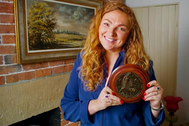 Irita Marriott with a death plaque or widow's penny of which more than a million were issued during the First World War to commemorate those who never came home. Irita sells this artefact on behalf of a Belper resident in the first episode of the new series of The Derbyshire Auction House which began on the Really channel this week (photo: Really UK)